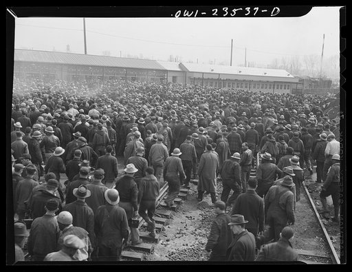 Untitled photo, possibly related to: Bethlehem-Fairfield shipyards, Baltimore, Maryland. Day shift lining up in front of the time clocks