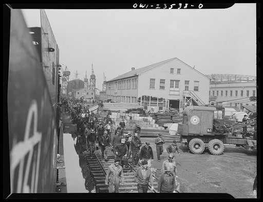 Bethlehem-Fairfield shipyards, Baltimore, Maryland. Day shift walking toward the time clocks
