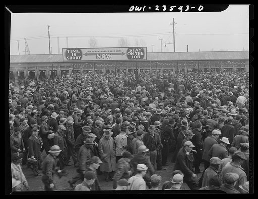 Bethlehem-Fairfield shipyards, Baltimore, Maryland. Day shift lining up in front of the time clocks