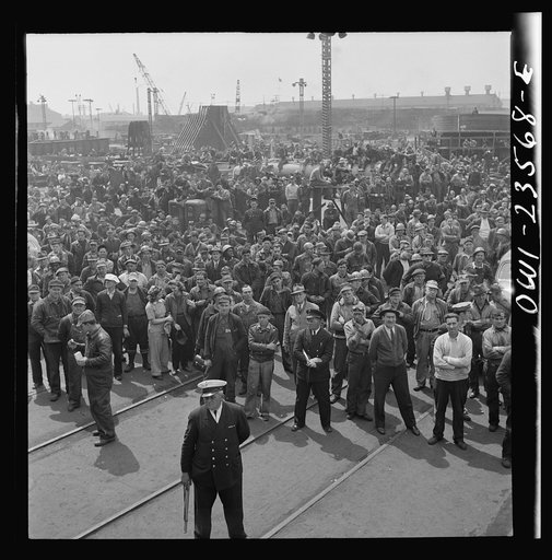 Bethlehem-Fairfield shipyards, Baltimore, Maryland. Shipyard workers attending a launching ceremony
