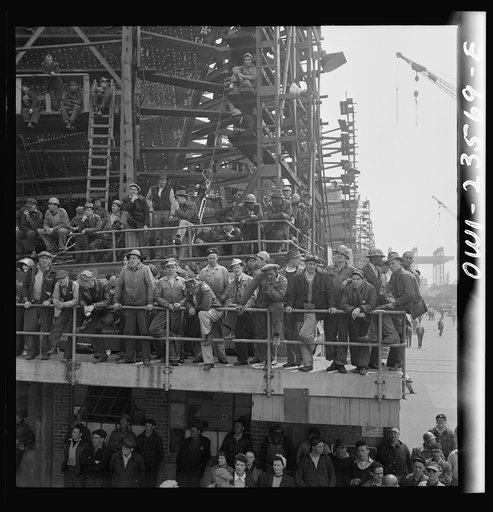 Bethlehem-Fairfield shipyards, Baltimore, Maryland. Shipyard workers watching a launching ceremony