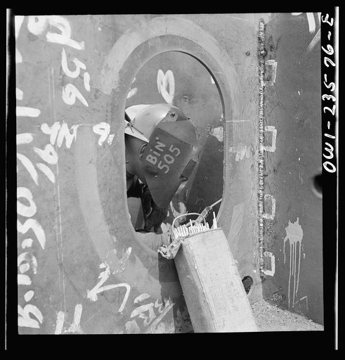 Untitled photo, possibly related to: Bethlehem-Fairfield shipyards, Baltimore, Maryland. Welding the floor to a vertical keel