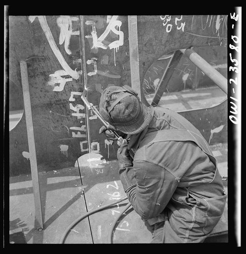 Bethlehem-Fairfield shipyards, Baltimore, Maryland. Burner working on an inner bottom unit