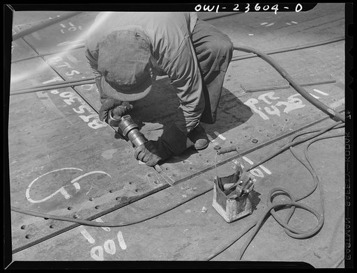Bethlehem-Fairfield shipyards, Baltimore, Maryland. Chipper beveling shell plates for welding