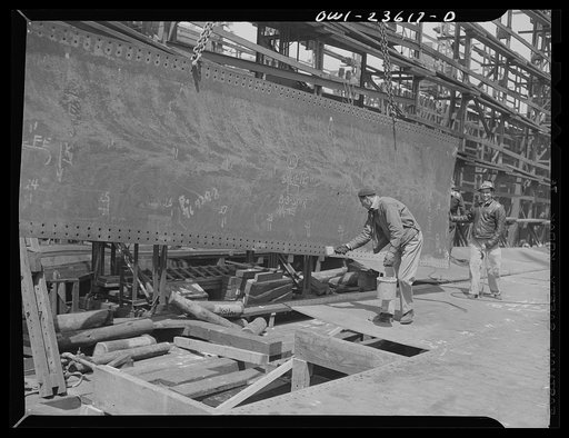 Bethlehem-Fairfield shipyards, Baltimore, Maryland. Painting the bottom shell seams