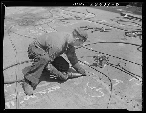 Bethlehem-Fairfield shipyards, Baltimore, Maryland. Beveling a bottom shell plating for welding