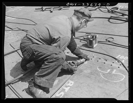 Bethlehem-Fairfield shipyards, Baltimore, Maryland. Beveling a bottom shell plating for welding