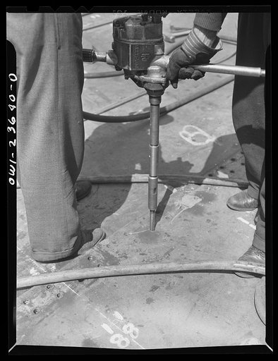 Bethlehem-Fairfield shipyards, Baltimore, Maryland. Reaming rivet holes in bottom shell plating