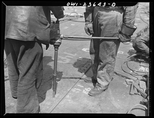 Bethlehem-Fairfield shipyards, Baltimore, Maryland. Reaming bottom shell plating rivet holes