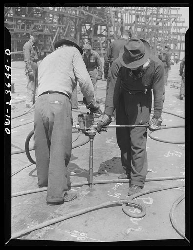 Bethlehem-Fairfield shipyards, Baltimore, Maryland. Reaming bottom shell plating rivet holes