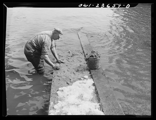 Bethlehem-Fairfield shipyards, Baltimore, Maryland. Greasing the outboard launching ways