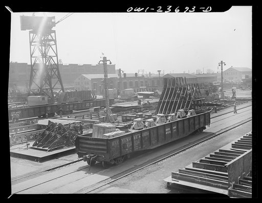 Bethlehem-Fairfield shipyards, Baltimore, Maryland. Auxiliary machinery brought to the ways in a gondola. The sub-assembly area is in the background
