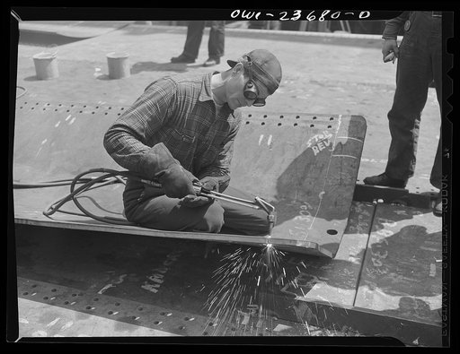 Bethlehem-Fairfield shipyards, Baltimore, Maryland. Burning a flat keel plate