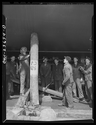 Bethlehem-Fairfield shipyards, Baltimore, Maryland. Removing shoring preparatory to launching ceremony