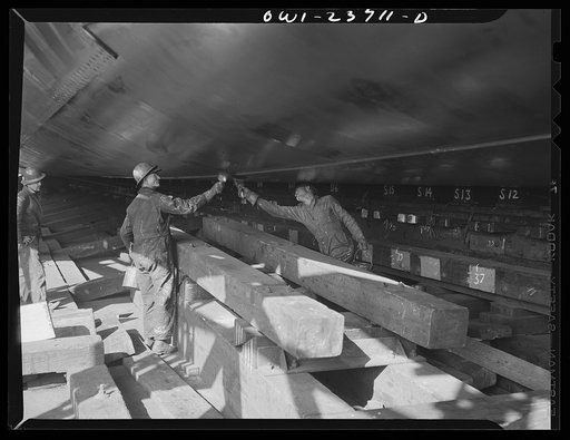 Bethlehem-Fairfield shipyards, Baltimore, Maryland. Painting the bottom shell of a vessel where shoring had been during the construction of the vessel