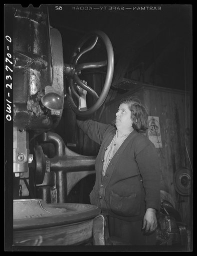 Buffalo, New York. Italian-American woman operating a hand-controlled boring machine which makes holes through locomotive wheels at the New York Car Wheel Company, makers of locomotive wheels for the railroads