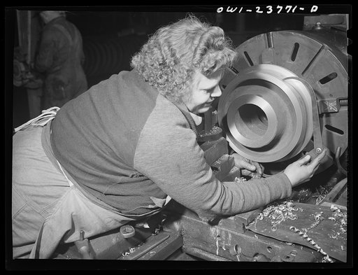 Buffalo, New York. Polish-American woman measuring part of a locomotive wheel with calipers. She operates the lathe on which it is being finished at the New York Car Wheel Company, makers of locomotive wheels for the railroads