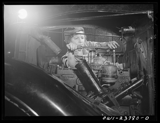 Untitled photo, possibly related to: Buffalo, New York. Woman learning to be an automobile mechanic at the Burgard Vocational High School. She is drawing down the cylinder head of an automotive engine with the use of a toisinal wrench