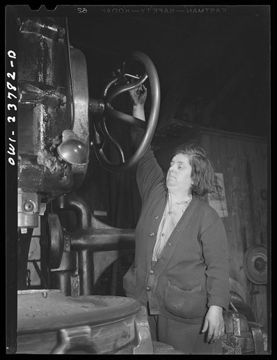 Untitled photo, possibly related to: Buffalo, New York. Italian-American woman operating a hand-controlled boring machine which makes holes through locomotive wheels at the New York Car Wheel Company, makers of locomotive wheels for the railroads