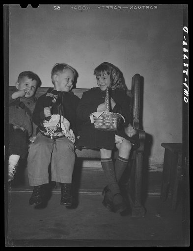 Buffalo, New York. Children of the Polish community waiting in church on the day before Easter with baskets of food to be blessed by the priest. This ceremony celebrated the breaking of Lenten fasting, and the food is eaten on Easter day