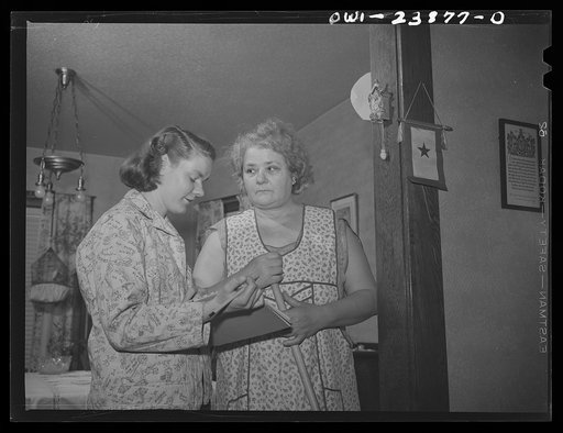 Untitled photo, possibly related to: Niagara Falls, New York. Nan Hannegan doing door to door recruiting for women to work in war plants. This program was organized by the War Manpower Commission in cooperation with local war plants who loaned nineteen women workers