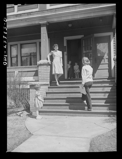 Niagara Falls, New York. Nan Hannegan doing door to door recruiting for women to work in war plants. This program was organized by the War Manpower Commission in coopration with local war plants who loaned nineteen women workers