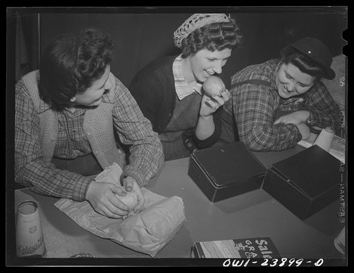 Buffalo, New York. Women employees eating lunches brought from home at Ross Heater, makers of condensers for the Navy. There are no eating facilities in the plant, and since there is only a thirty-minute period, most workers bring lunches