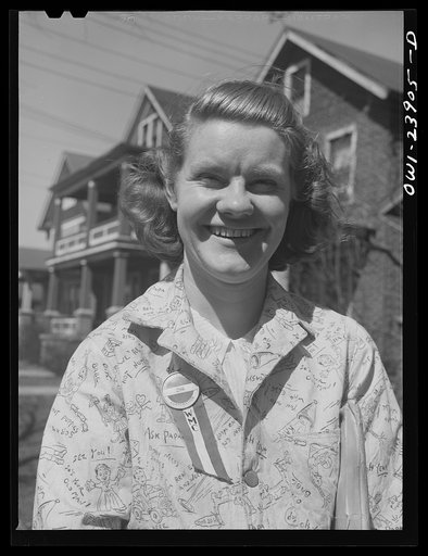Niagara Falls, New York. Nan Hannegan doing door to door recruiting for women to work in war plants. This program was organized by the War Manpower Commission in cooperation with local war plants who loaned nineteen women workers. Nan wears a War Manpower Commission ribbon pinned on with her plant b