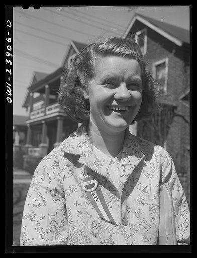 Untitled photo, possibly related to: Niagara Falls, New York. Nan Hannegan doing door to door recruiting for women to work in war plants. This program was organized by the War Manpower Commission in cooperation with local war plants who loaned nineteen women workers. Nan wears a War Manpower Commiss