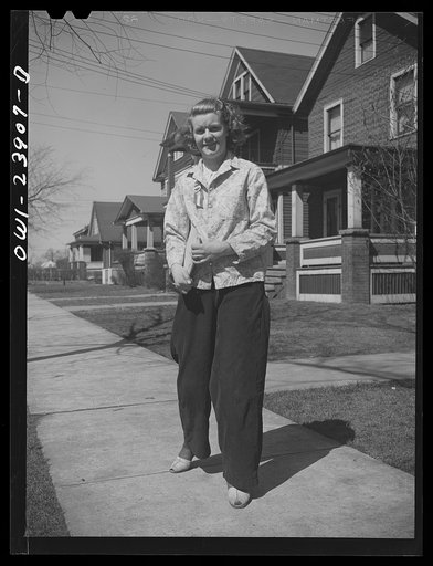 Untitled photo, possibly related to: Niagara Falls, New York. Nan Hannegan doing door to door recruiting for women to work in war plants. This program was organized by the War Manpower Commission in cooperation with local war plants who loaned nineteen women workers. Nan wears a War Manpower Commiss