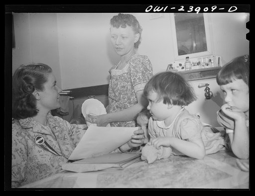 Untitled photo, possibly related to: Niagra Falls, New York. Nan Hannegan doing door to door recruiting for women to work in war plants. This program was organized by the War Manpower Commission in cooperation with local war plants who loaned nineteen women workers