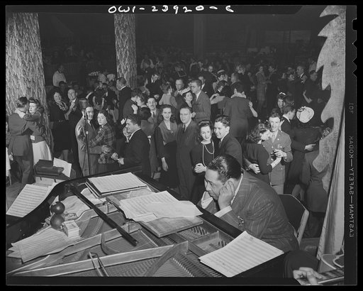 New York, New York. Duke Ellington plugs his ears with his fingers so that he may hear more definitely the orchestration being played by members of his band at the Hurricane Ballroom