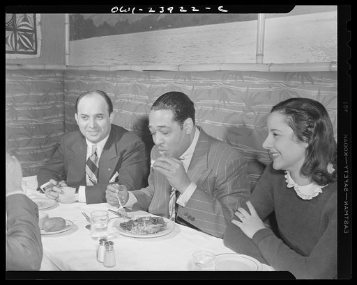 New York, New York. Duke Ellington having his dinner at the Hurricane with his wife, Bea Ellington, and a friend