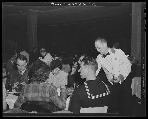 New York, New York. Waiter at the Hurricane serving patrons