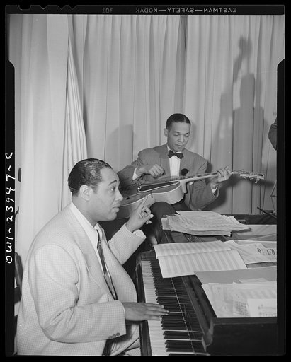 New York, New York. Duke Ellington directing his band from the piano at the Hurricane cabaret