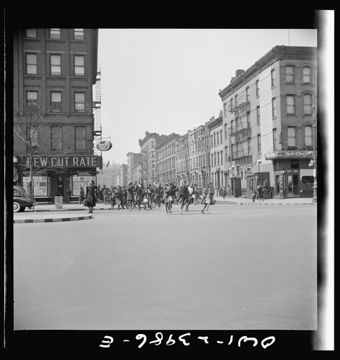 New York, New York. Many accidents are attributed to unpatrolled intersections in Harlem. Here school children are allowed to run across busy intersections unescorted