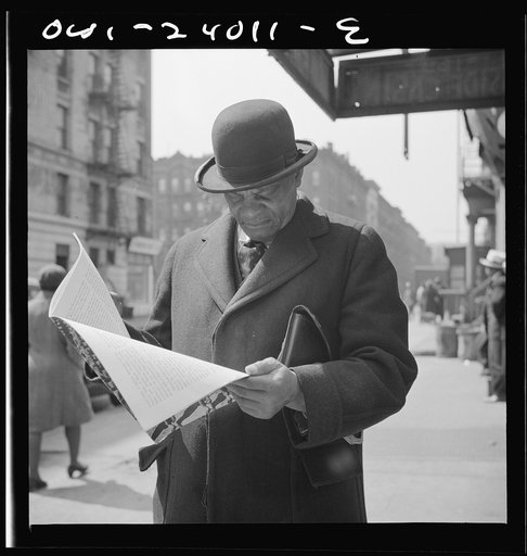 New York, New York. A Marcus Garveyite reading the OWI (Office of War Information) publication Negroes and the War