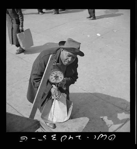 New York, New York. Street peddler in Harlem weighing string beans