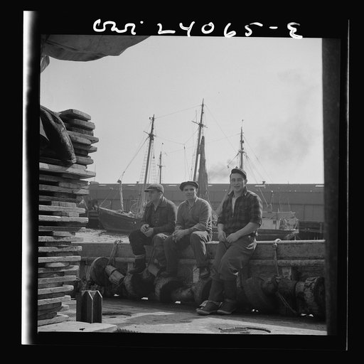 New York, New York. Gloucester fishermen resting on their boat at the Fulton fish market