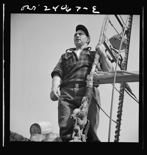 New York, New York. Gloucester fisherman standing in the rigging of a New England fishing boat