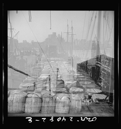 Untitled photo, possibly related to: New York, New York. Barrels of fish on the docks at the Fulton fish market ready to be shipped to retailers