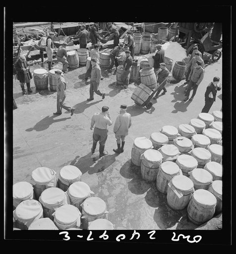 New York, New York. Barrels of fish on the docks at Fulton fish market ready to be shipped to retailers