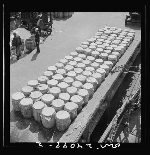 New York, New York. Barrels of fish on the docks at Fulton fish market ready to be shipped to retailers