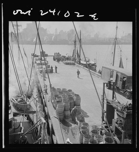 New York, New York. A scene at the Fulton fish market showing the dock where New England fishing boats unload their cargo