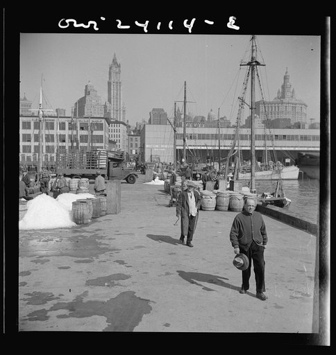 Untitled photo, possibly related to: New York, New York. Barrels of fish on the docks at Fulton fish market ready to be shipped to retailers