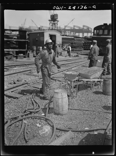 Baltimore, Maryland. Rivet heater engaged in the construction of the Liberty ship Frederick Douglass at the Bethlehem-Fairfield shipyards