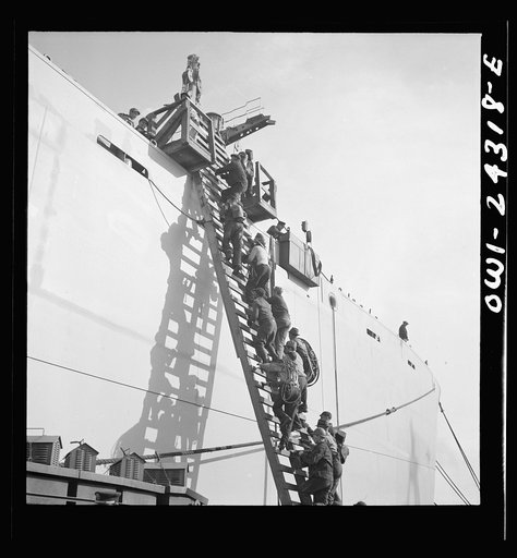 Bethlehem-Fairfield shipyards, Baltimore, Maryland. Workers ascending a ladder at the outfitting pier
