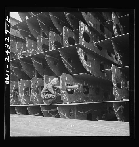 Bethlehem-Fairfield shipyards, Baltimore, Maryland. Pipefitters at work in the innerbottom sections