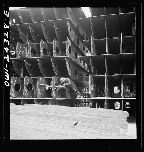 Bethlehem-Fairfield shipyards, Baltimore, Maryland. Pipefitters at work in the innerbottom sections