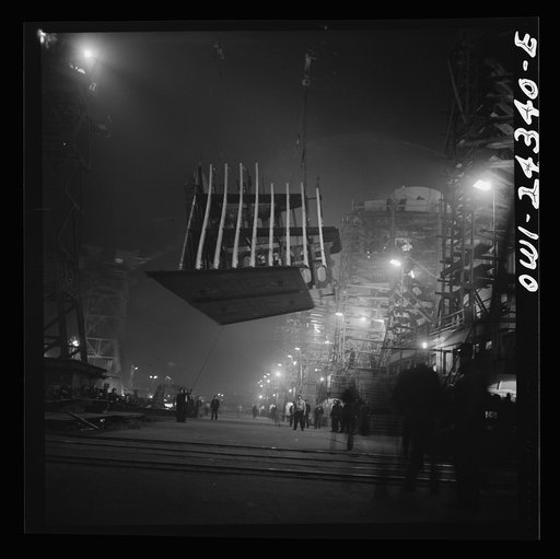 Untitled photo, possibly related to: Bethlehem-Fairfield shipyards, Baltimore, Maryland. Lifting an after peak section at night
